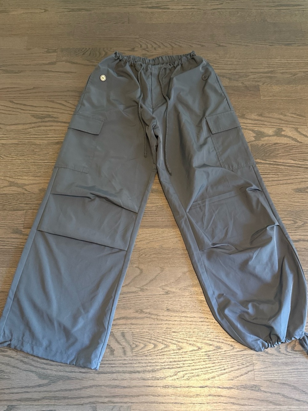 Women’s Gray Cargo Drawstring Pants with drawstring waist and at ankles.